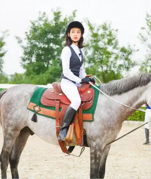 只见她身着一袭红裳,戴着具有异域气息的配饰,骑马奔腾在大草原上.