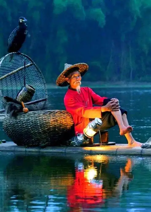 竹筏鱼鹰河水清,斗笠蓑衣老翁挺.