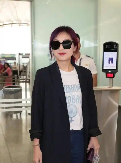 杨千嬅黑色西装外套配运动鞋弯腰捂嘴调皮偷笑_机场_照片_墨镜