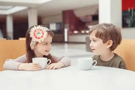 两个白人白种人可爱可爱有趣的孩子们坐在一起喝果汁组肖像.